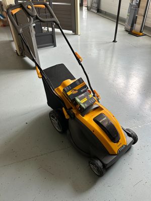 the yellow and black lawn mower is sitting on the floor in the room