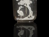 a glass snuff bottle with a picture of a bird on it
