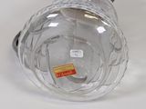 a glass vase with a label on it on a table
