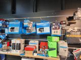 many different types of electronics on the shelves in the store
