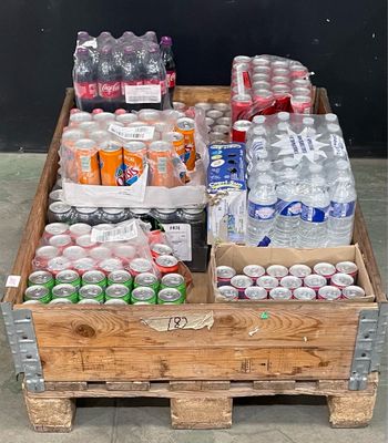 a wooden crate filled with bottles of soda and water