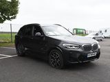 a black bmw suv parked in a parking lot