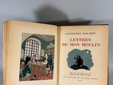 an open book with a picture of a man sitting on a chair in front of a window