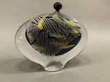 a glass vase with a black and yellow design on it