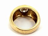 a close up of a gold ring with a diamond in it