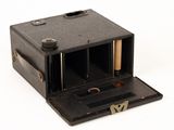 a small black box with a wooden handle on a white surface