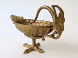 an image of a brass bowl with a bird on it
