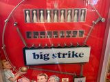 a big strike machine in a store with a sign on it