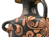 a black and orange vase with a design on it