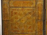 pair of antique wooden doors with intricate designs on them