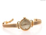 une image représentant une montre-bracelet pour femme sur fond blanc