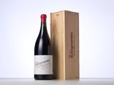 a bottle of wine sitting next to a wooden box