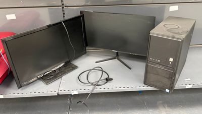 trois écrans et un ordinateur posés sur une étagère dans un magasin