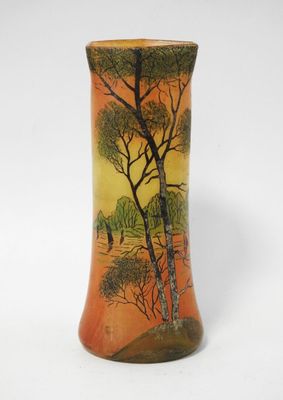 an orange vase with a painting of a tree and a bird on it