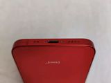 a close up of the rear of a red iphone with a white background