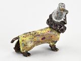 figurine of a dachshund dog with a hat on its head