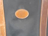 a black bag with a brown handle and a brown handle
