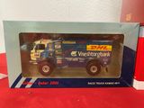 toy truck in box on table with red table cloth and red table cloth