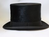 a black top hat with a bow tie on it