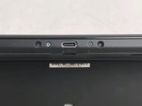 a close up of the back of a laptop computer with a small button on it