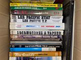 many books in a box that are stacked on top of each other