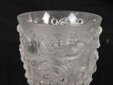 a clear glass cup with a flower design on it