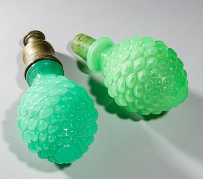 two green lights that are on top of a white table