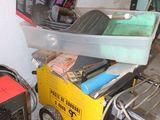 a small portable generator sitting next to a box of tools