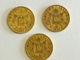 three gold sovereigns, one of which is a sovereign and the other of which is a sovereign