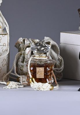 a small bag of honey next to a bottle of honey