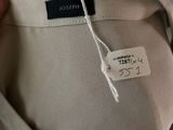 the back of a woman ' s pants with a label on it
