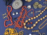 many different types of jewelry on a blue surface
