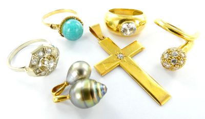 several different rings and rings with a cross on a white surface