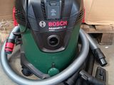 a vacuum that is sitting on the floor next to a box