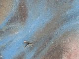 a close up of a person ' s face with blue and black paint on it