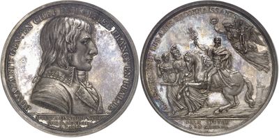two silver medallions depicting a man riding a horse and a woman riding a horse