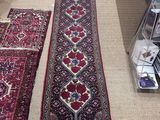 two rugs on the floor in a room with a desk and chair