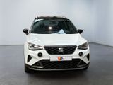 the front view of a white car in a white room