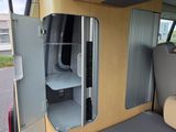 a small bed in the back of a camper van