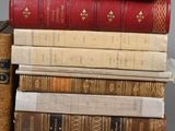 several books stacked on top of each other on a table