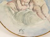 a picture of a plate with a painting of two babies on it