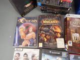 a lot of video games and dvds on the table