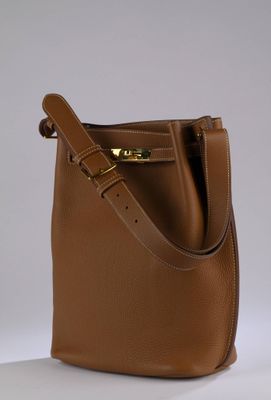 brown leather bucket bag on white background