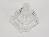 a clear glass ashtray on a white surface