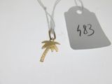 a gold palm tree charm with a price tag on it