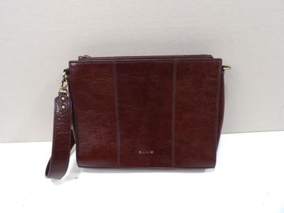 a close up of a brown purse on a white surface