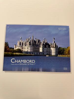 a poster of a castle on the wall above the water