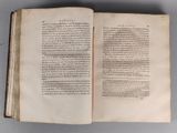 an open book with a page of text on it sitting on top of a table