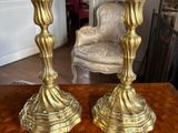two candles that are sitting on a wooden table