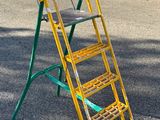 a yellow ladder that is sitting in the middle of the road